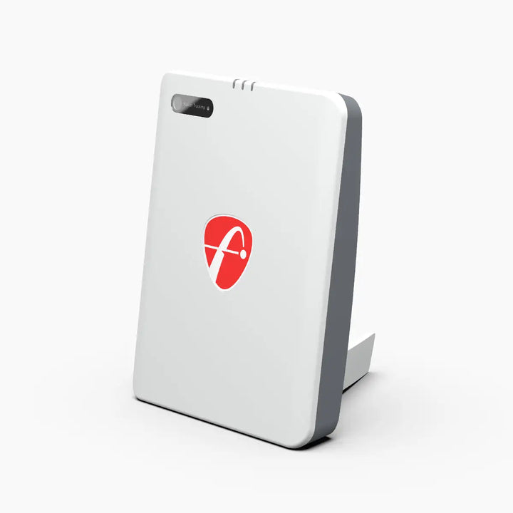 Side view of the FlightScope Mevo Plus launch monitor on a white background, showing its sleek white design with a red logo.